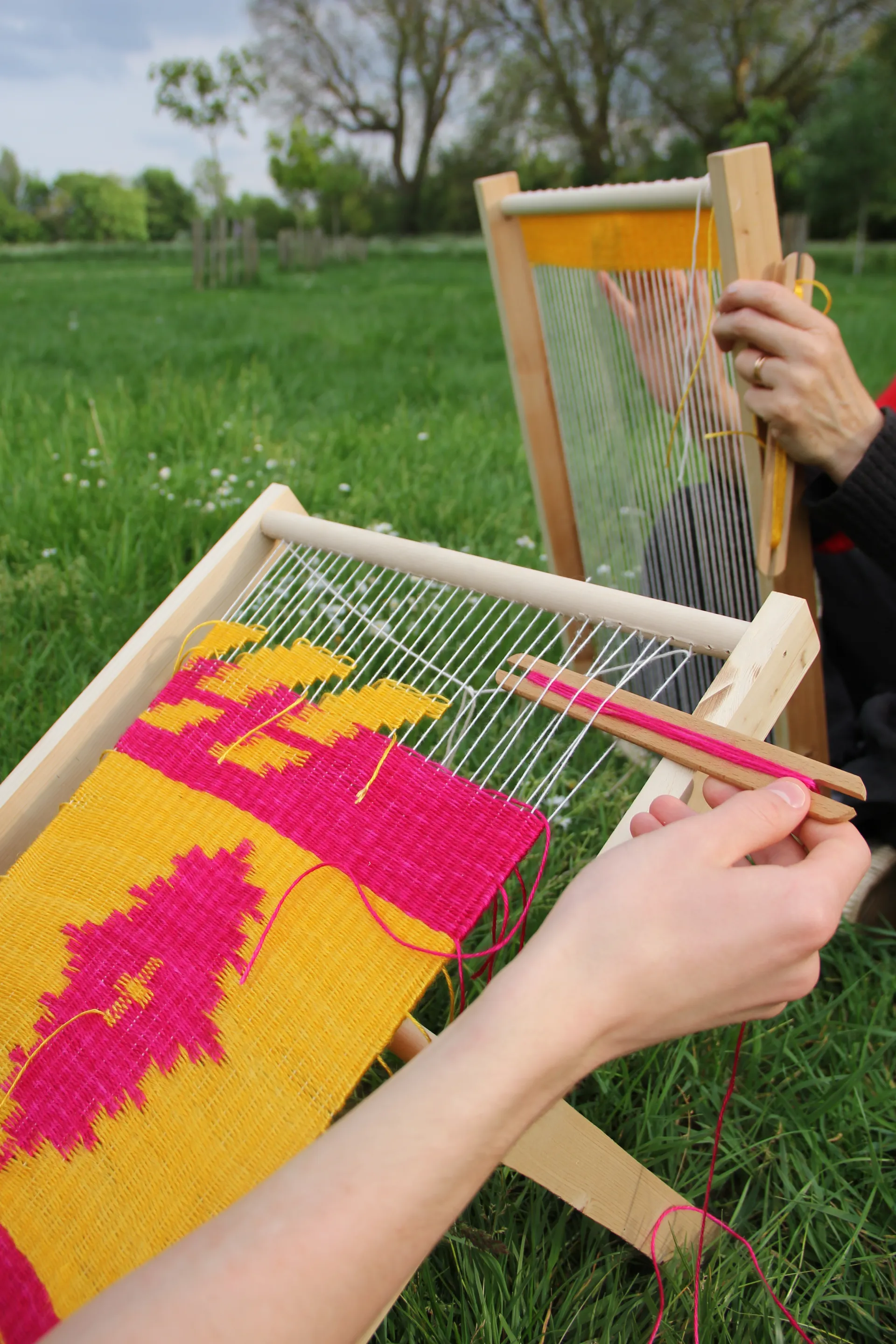 Two people weaving in a park.